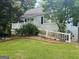 Cozy home with a white picket fence and a well-maintained lawn at 2606 Ramblewood Ct, Acworth, GA 30102