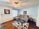 Cozy living room with hardwood floors, a comfortable sofa, and a glass coffee table at 2606 Ramblewood Ct, Acworth, GA 30102