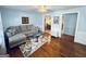 Cozy living room with hardwood floors, a comfortable sofa, and a glass coffee table at 2606 Ramblewood Ct, Acworth, GA 30102