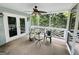 Cozy screened-in porch with seating and a ceiling fan offers a relaxing outdoor retreat at 2606 Ramblewood Ct, Acworth, GA 30102