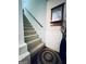 Carpeted stairway with wood railing and wainscoting, creating an inviting entryway at 2606 Ramblewood Ct, Acworth, GA 30102