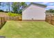 Expansive backyard with lush grass, a fence, and trees at 1018 Nandina Ct, Villa Rica, GA 30180