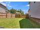 A well-maintained backyard featuring lush green grass and a sturdy wooden fence at 1018 Nandina Ct, Villa Rica, GA 30180
