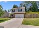 Charming two-story home with a brick-accented garage, a well-maintained lawn, and a driveway at 1018 Nandina Ct, Villa Rica, GA 30180