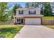 Inviting two-story home featuring brick accents, a two-car garage, and a well-manicured front lawn at 1018 Nandina Ct, Villa Rica, GA 30180