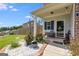 Welcoming front porch with seating area, plants, and decorative touches at 1018 Nandina Ct, Villa Rica, GA 30180