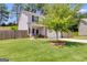 Inviting home with a well-kept lawn, mature tree, and a cozy front porch at 1018 Nandina Ct, Villa Rica, GA 30180