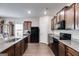 Spacious kitchen features granite counters, black appliances, and dark wood cabinets at 1018 Nandina Ct, Villa Rica, GA 30180