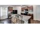 Bright kitchen with granite counters, center island, dark cabinets and stainless steel appliances at 1018 Nandina Ct, Villa Rica, GA 30180