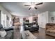 Open-concept living area with dark wood floors, ceiling fan, and lots of natural light at 1018 Nandina Ct, Villa Rica, GA 30180