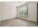 Cozy bedroom with wood-look floors, a large window, and ceiling fan at 7505 Bishop Rd, Fairburn, GA 30213