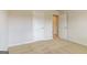 Carpeted bedroom with neutral walls, showcasing doors to the ensuite bath and walk-in closet at 189 Orwell Dr # 47, Social Circle, GA 30025