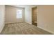 Carpeted bedroom featuring a large window providing natural light and access to the walk-in closet at 189 Orwell Dr # 47, Social Circle, GA 30025