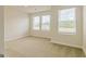 Bright bedroom with three windows offering an abundance of natural light and plush carpeting at 189 Orwell Dr # 47, Social Circle, GA 30025