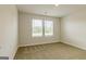 Bright bedroom with two windows providing natural light and cozy carpet, creating a relaxing space at 189 Orwell Dr # 47, Social Circle, GA 30025
