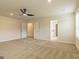 Spacious bedroom featuring neutral carpet, ceiling fan, and ensuite bathroom and walk-in closet access at 189 Orwell Dr # 47, Social Circle, GA 30025