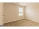 Cozy bedroom featuring a large window providing natural light and neutral-colored carpet, offering comfort at 189 Orwell Dr # 47, Social Circle, GA 30025