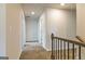 Upstairs hallway with neutral-colored walls and carpet, providing access to various rooms and a cozy feel at 189 Orwell Dr # 47, Social Circle, GA 30025