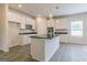 Modern kitchen featuring white cabinets, granite countertops, stainless steel appliances, and a center island at 189 Orwell Dr # 47, Social Circle, GA 30025