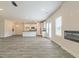 Open-concept living space with wood-look flooring, a fireplace, and seamless connection to the modern kitchen at 189 Orwell Dr # 47, Social Circle, GA 30025