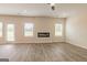 Bright living room featuring a modern fireplace, wood-look flooring, and ample natural light from large windows at 189 Orwell Dr # 47, Social Circle, GA 30025