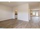 Open living area with wood-look floors, with a glimpse of the kitchen and pantry, offering a seamless flow at 189 Orwell Dr # 47, Social Circle, GA 30025