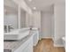 Bright bathroom featuring double sinks with granite counters and wood-look flooring at 271 Orwell Dr # 49, Social Circle, GA 30025