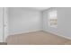 Carpeted bedroom features a single window, neutral walls, and ample natural light at 271 Orwell Dr # 49, Social Circle, GA 30025