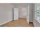 Bedroom featuring modern, wood-look flooring and an open doorway to another room at 271 Orwell Dr # 49, Social Circle, GA 30025
