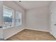 Bedroom featuring modern, wood-look flooring and two windows providing natural light at 271 Orwell Dr # 49, Social Circle, GA 30025