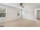Spacious bedroom features a ceiling fan, two windows, and neutral carpeting at 271 Orwell Dr # 49, Social Circle, GA 30025
