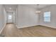 Bright dining area features wood-look floors, natural light, and modern chandelier at 271 Orwell Dr # 49, Social Circle, GA 30025