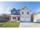 Two-story home boasting a brick facade, a two-car garage, and a well-manicured lawn at 271 Orwell Dr # 49, Social Circle, GA 30025