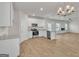 Modern kitchen features stainless appliances and is open to the living and dining area at 271 Orwell Dr # 49, Social Circle, GA 30025