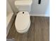 A clean toilet with an electronic bidet and wood-look flooring at 271 Orwell Dr # 49, Social Circle, GA 30025