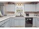 View of the kitchen's gray cabinets, white countertops, and stainless steel appliances at 349 Majestic Run, Temple, GA 30179