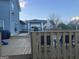 Spacious back deck with fenced railing, outside seating, and partially enclosed living space at 25 Franklin Way, Covington, GA 30016