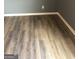 This bedroom has gray walls, white trim, and light hardwood flooring at 25 Franklin Way, Covington, GA 30016