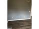 This bedroom boasts gray walls, white trim, and dark hardwood flooring for a modern design at 25 Franklin Way, Covington, GA 30016