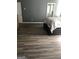 Bedroom featuring gray walls, a plush bed, and wood-look floors, creating a cozy retreat at 25 Franklin Way, Covington, GA 30016