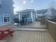 Spacious wooden deck featuring an outdoor dining set and a small gazebo at 25 Franklin Way, Covington, GA 30016
