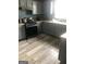Kitchen with granite countertops, a range and microwave, and gray cabinets on wood-look floors at 25 Franklin Way, Covington, GA 30016