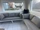 Enclosed back porch area furnished with comfortable seating and sliding door access to the outside at 25 Franklin Way, Covington, GA 30016