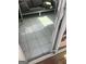 View of the sunroom with outdoor sofa, tile flooring, and glass door at 25 Franklin Way, Covington, GA 30016