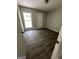 Bright bedroom featuring wood-look flooring and a large window at 2961 Forelock Sw Pl, Marietta, GA 30064