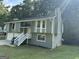 Green two-story house with white accents, two car garage and stairs leading to the entrance at 2961 Forelock Sw Pl, Marietta, GA 30064