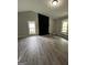 Living room with wood-look floors, a fireplace, and bay window at 2961 Forelock Sw Pl, Marietta, GA 30064