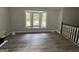 Living room with bay window, wood-look floors and staircase at 2961 Forelock Sw Pl, Marietta, GA 30064