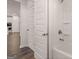 Bathroom with tub/shower combination and open door leading to the kitchen and other parts of the home at 1678 Lacebark Elm Way, Lawrenceville, GA 30045