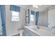 Well-lit bathroom with blue accents, modern vanity, and framed artwork at 1678 Lacebark Elm Way, Lawrenceville, GA 30045
